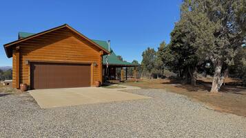 Escape to a secluded cabin surrounded by mature trees and a tranquil atmosphere.