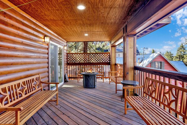 Front porch area with seating and a fire pit to enjoy a relaxing evening.