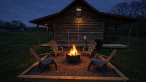 A rustic wooden cabin with a fire pit and Adirondack chairs in the yard. - The Cabin in Tracy City (Tracy City)