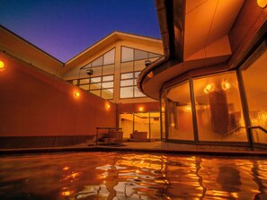 A building with large windows and a reflective pool in front. - ART HOTEL Kashima Central (Kamisu)