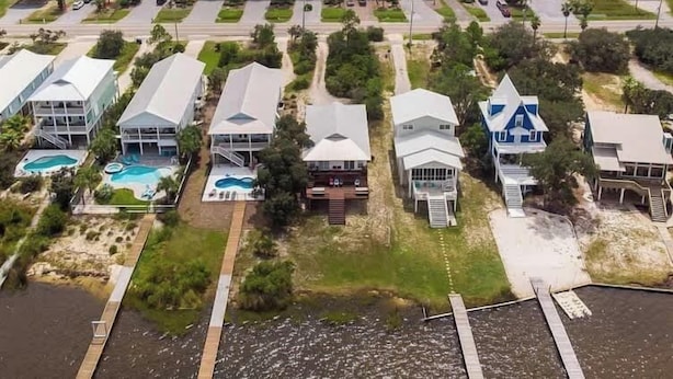 A coastal residential area with houses, a beach, and a marina. - Book w/ Phone + Save 10%! Private Pool + Walk 2 Beach! (Gulf Shores)