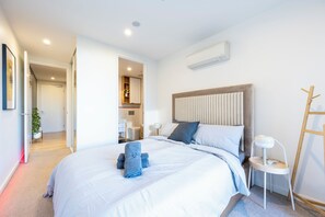 Relax in a spacious room with a large bed, bedside tables, and a loft-style design.