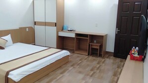 A bedroom with a bed, a desk, a chair, and a wardrobe. - Anh Trang Hostel LS - by BAY LUXURY (Tam Thanh)