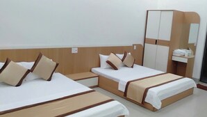A hotel room with three beds, a wardrobe, a desk, and a mirror. - Anh Trang Hostel LS - by BAY LUXURY (Tam Thanh)