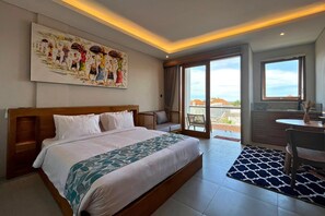 A hotel room with a large bed, a dining table, a sofa, and a balcony with a view. - Campbar 4 (Munggu)