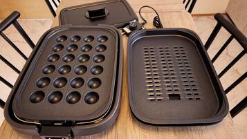 A waffle iron with a grid pattern and a non-stick surface.