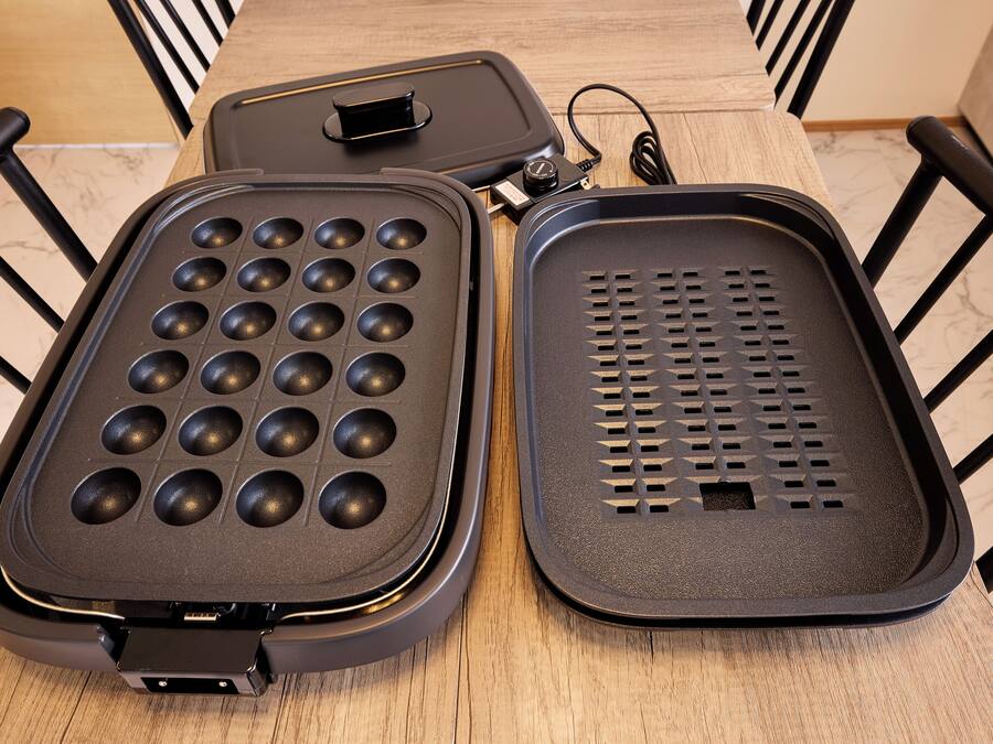 A waffle iron with a grid pattern and a non-stick surface.