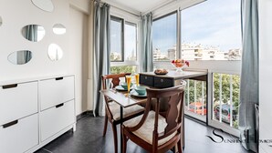 A modern kitchen with a dining area, large windows, and a view of the city. - Stylish Retreat: 1-Bed, Pool, Sleeps 3 REF001 (Benalmádena)