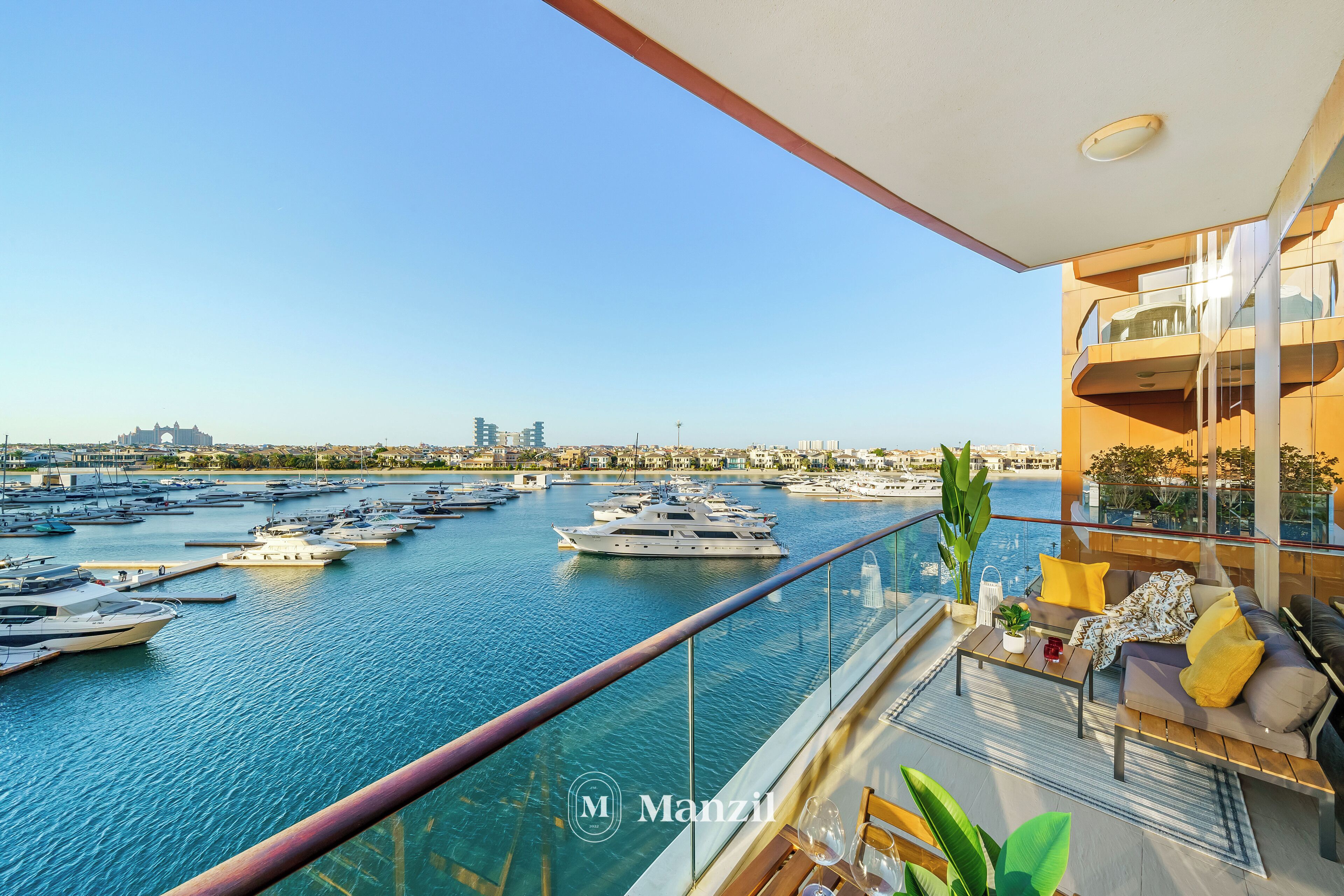 A balcony with a view of a marina, featuring multiple yachts and boats.