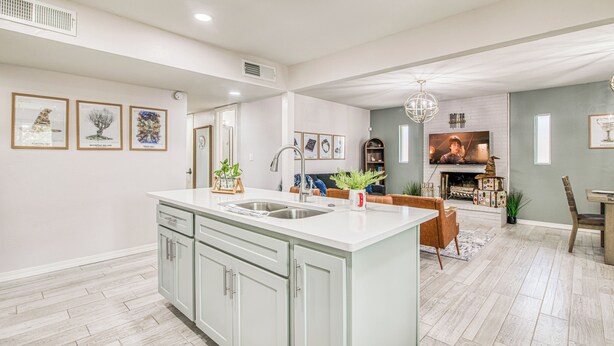 A spacious kitchen with a large island, a dining area with a fireplace, and a living room with a TV. - 3 bedroom 2 bath Magical home (El Paso)