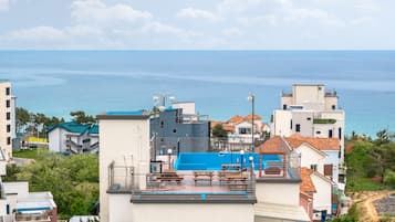 Enjoy a rooftop pool with ocean views surrounded by a deck and seating area.
