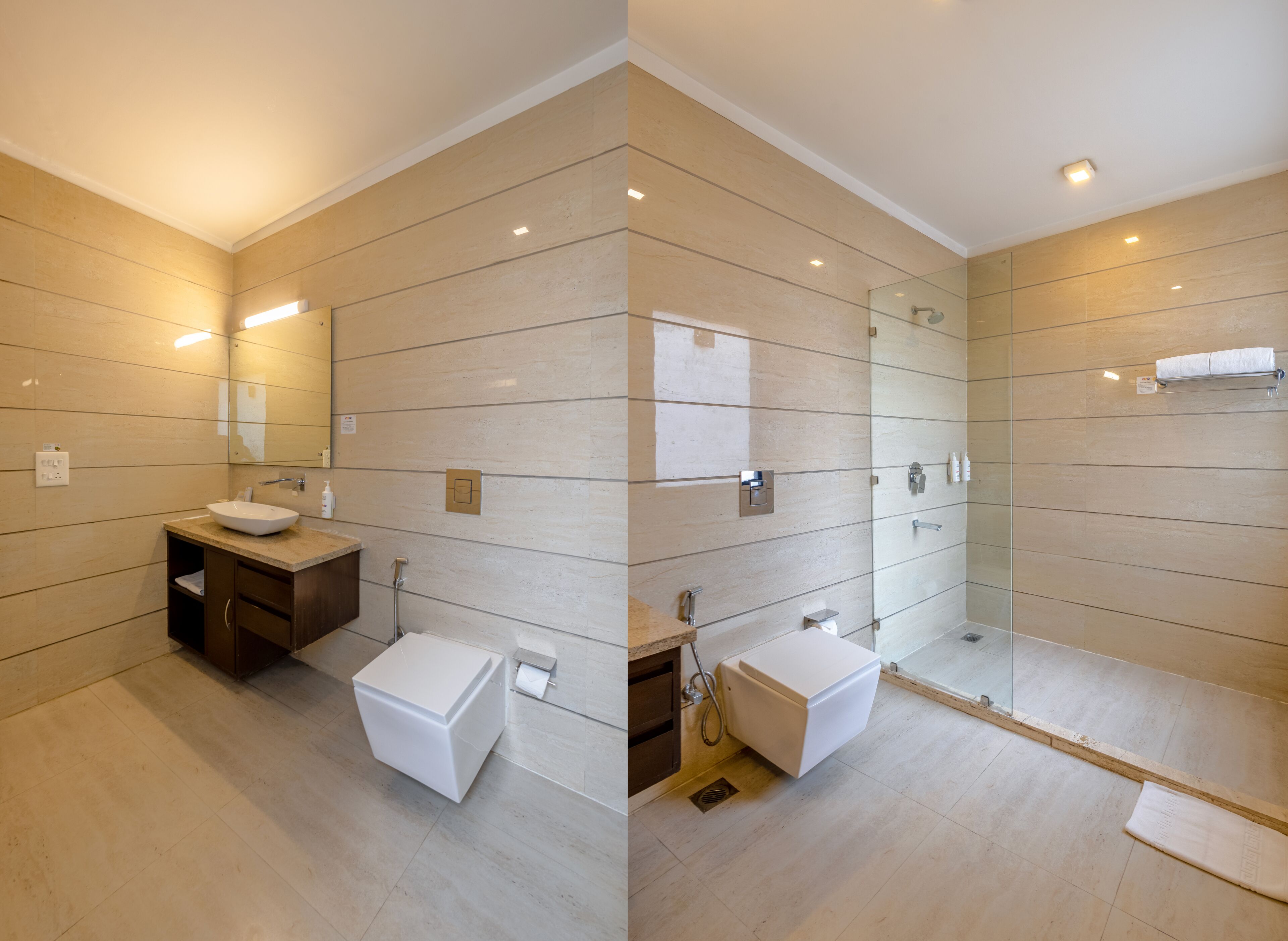 A modern bathroom with a large mirror, a sink, and a shower area.