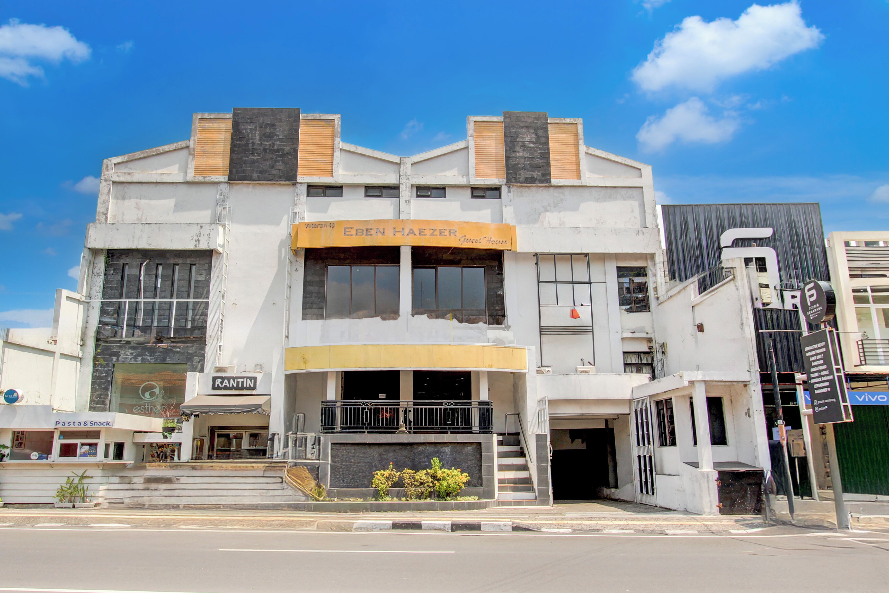 A building with a sign for 'Eben Haezer' and 'Kantin' on the ground floor.