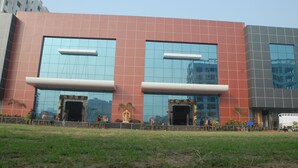 A modern building with large glass windows and a flat roof. - Hotel Vijya laxmi Rooms and Banquet Hall (Surat)