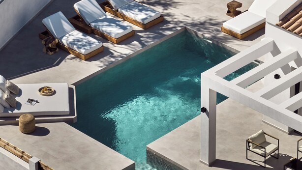 A modern outdoor pool area with lounge chairs and a small table. - Estelle Villa, a Flamboyant Escape (PRWP+7J Mouzaki, Greece)