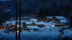 A snow-covered village with wooden houses and a clear night sky. - BZIKA Wonderland Retreat (Zhangjiajie)