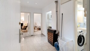 A laundry area with a washing machine, a drying rack, and a cabinet. - Apartment 'Die Edisonstraße' with Wi-Fi (Pforzheim)