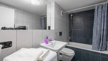 Combined shower/tub, hair dryer, towels, soap