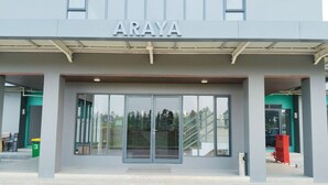 A building entrance with the name 'ARAYA' above the doors.