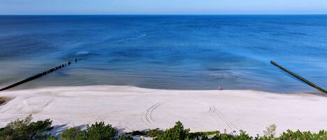 Beach nearby, white sand, windsurfing, sailing