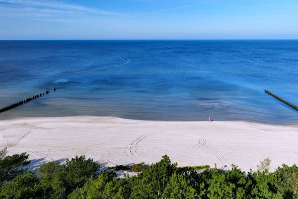Beach nearby, white sand, windsurfing, sailing