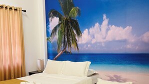 A hotel room with two beds, a large beach mural on the wall, and a checkered floor. - Castle Rock Boracay (Boracay Island)