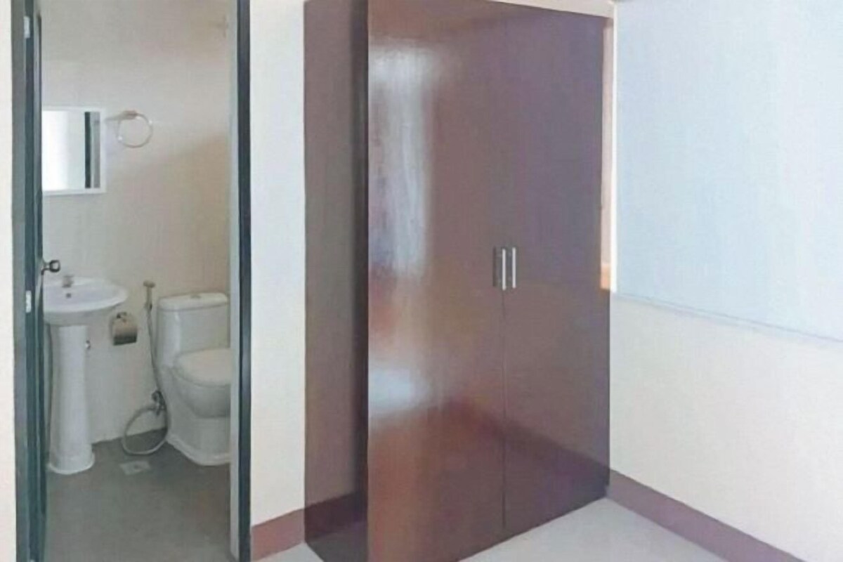 A bathroom with a toilet, sink, and mirror.