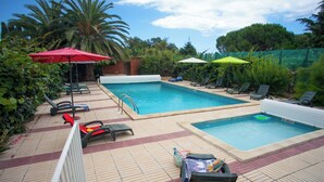 A pool area with two separate pools, lounge chairs, and umbrellas. - Massane gîte for 2 to 8 people at Mas la Couloumine (Elne)
