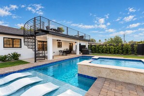 A residential property with a swimming pool, a covered patio, and a spiral staircase. - The Sundancer Oasis|Old Town|Pool+Spa|Rooftop Deck (Scottsdale)