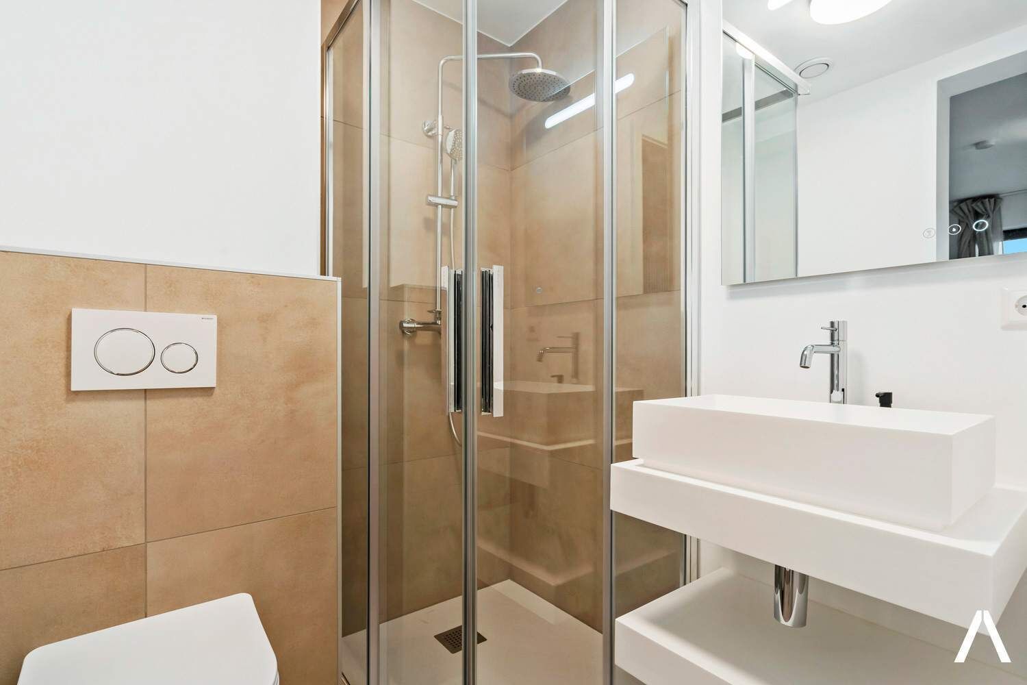A modern bathroom with a glass-enclosed shower, a white sink, and a wall-mounted control panel.