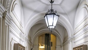 A grand staircase with a checkered floor, leading to a room with a chandelier. - Hidden Treasure-Campo de' Fiori (Rome)