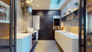 A modern kitchen with a central island, built-in appliances, and a sleek design. - 3-bedroom Penthouse in Knightbridge (London)
