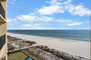A beach view from a balcony with a clear sky and calm sea. - Phoenix V 910 (Orange Beach)