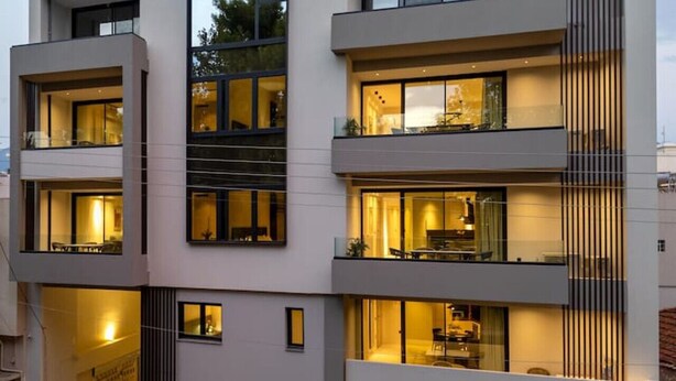 A modern multi-story building with balconies, large windows, and satellite dishes. - RiverSide Villas Kalamata B1 (Kalamata)