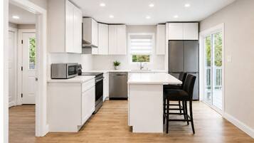 Coffee/tea maker, fridge, stovetop, lobster pot