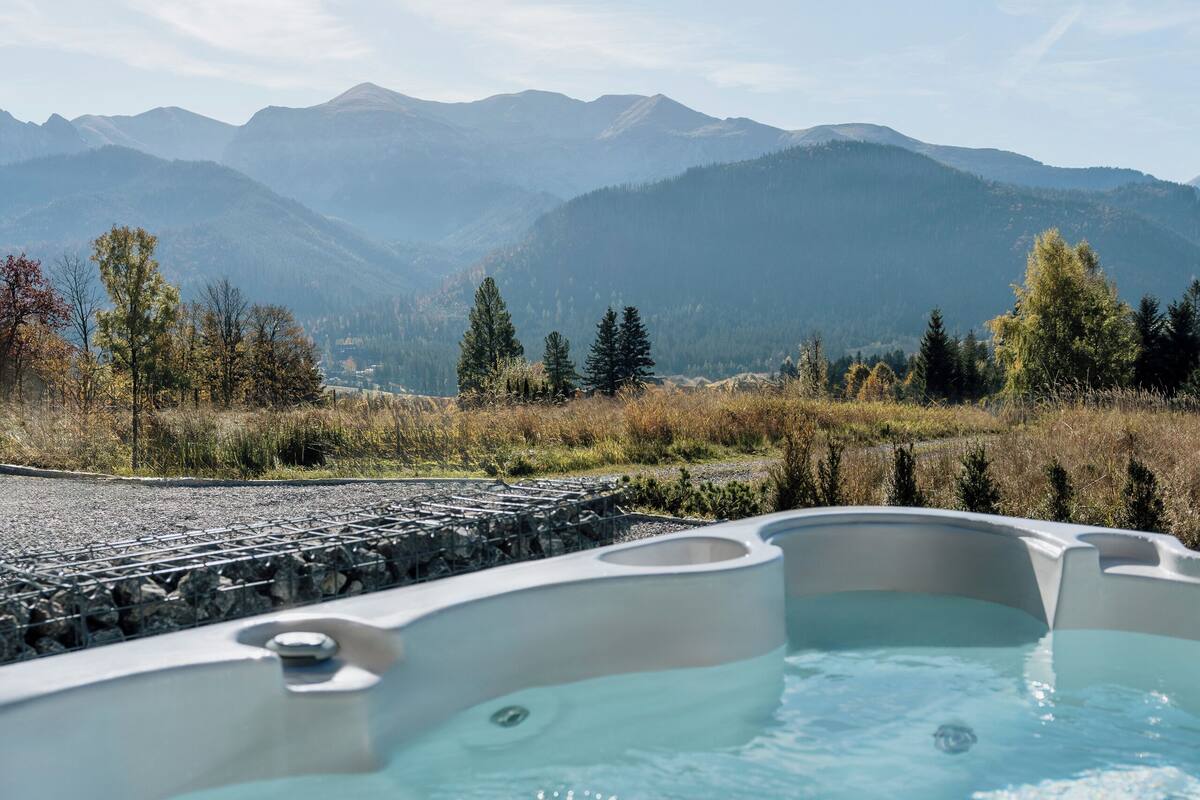 A hot tub with a mountainous backdrop.