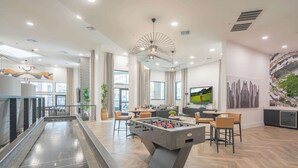 A modern indoor space with a foosball table, a pool table, and a bar area. - Near TPC - Pool, Gym, Hot Tub Pickleball, WD (Scottsdale)