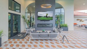 A reception area with a modern design, featuring a large TV screen, seating area, and a decorative wall. - Near TPC - Pool, Gym, Hot Tub Pickleball, WD (Scottsdale)