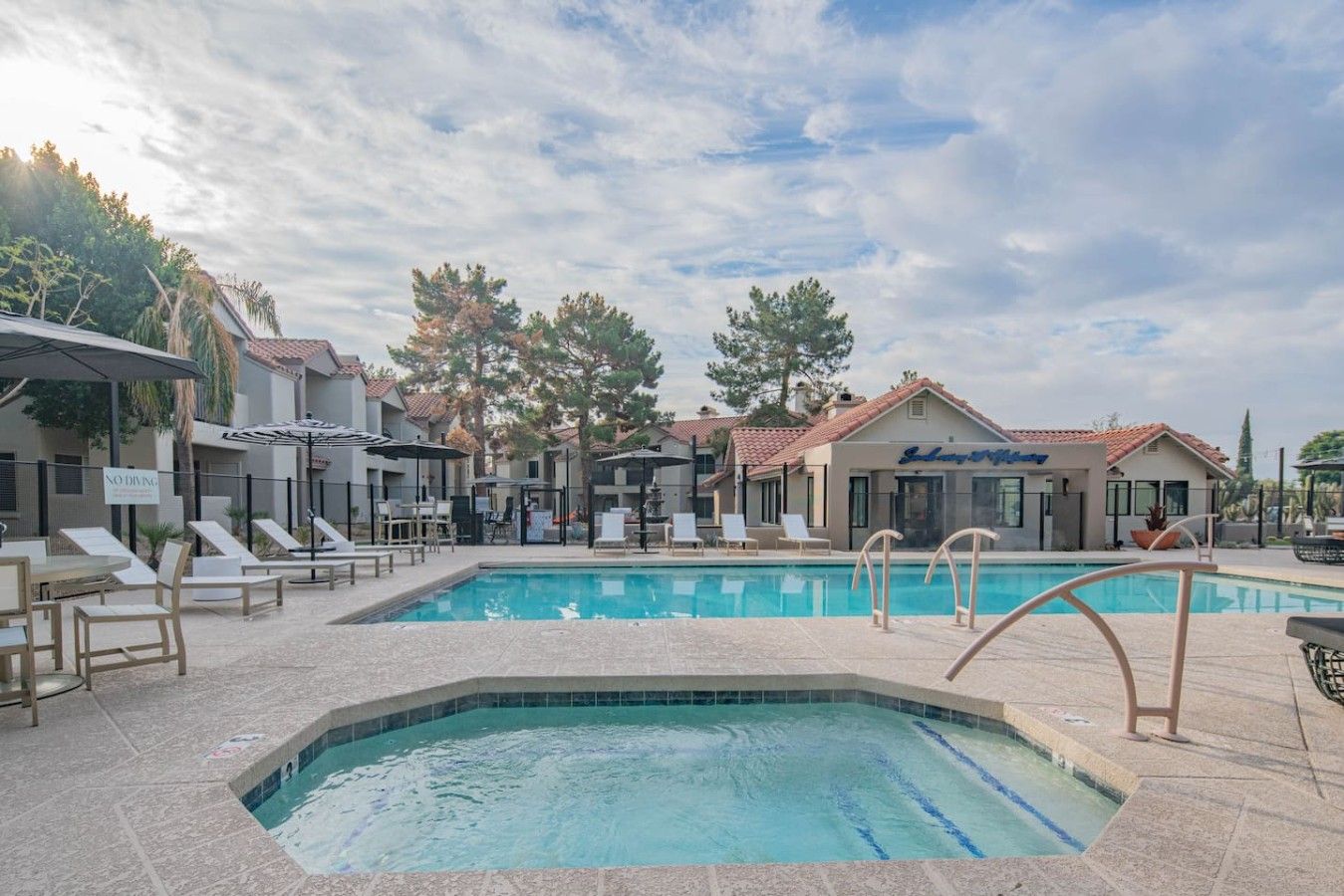 A swimming pool area with lounge chairs and a restaurant named 'Sofitel.'