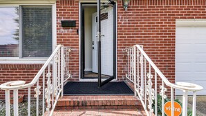A brick house with a white garage door, a black door, and a white staircase with a black mat at the bottom. - 3 Mi to Huntington Beach: Hampton Family Home! (Hampton)