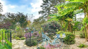 A garden with a stone pathway, a bicycle, and a sign that reads "GARDEN". - 4 Mi to Falls Lake: Dog-friendly Wake Forest Home (Wake Forest)