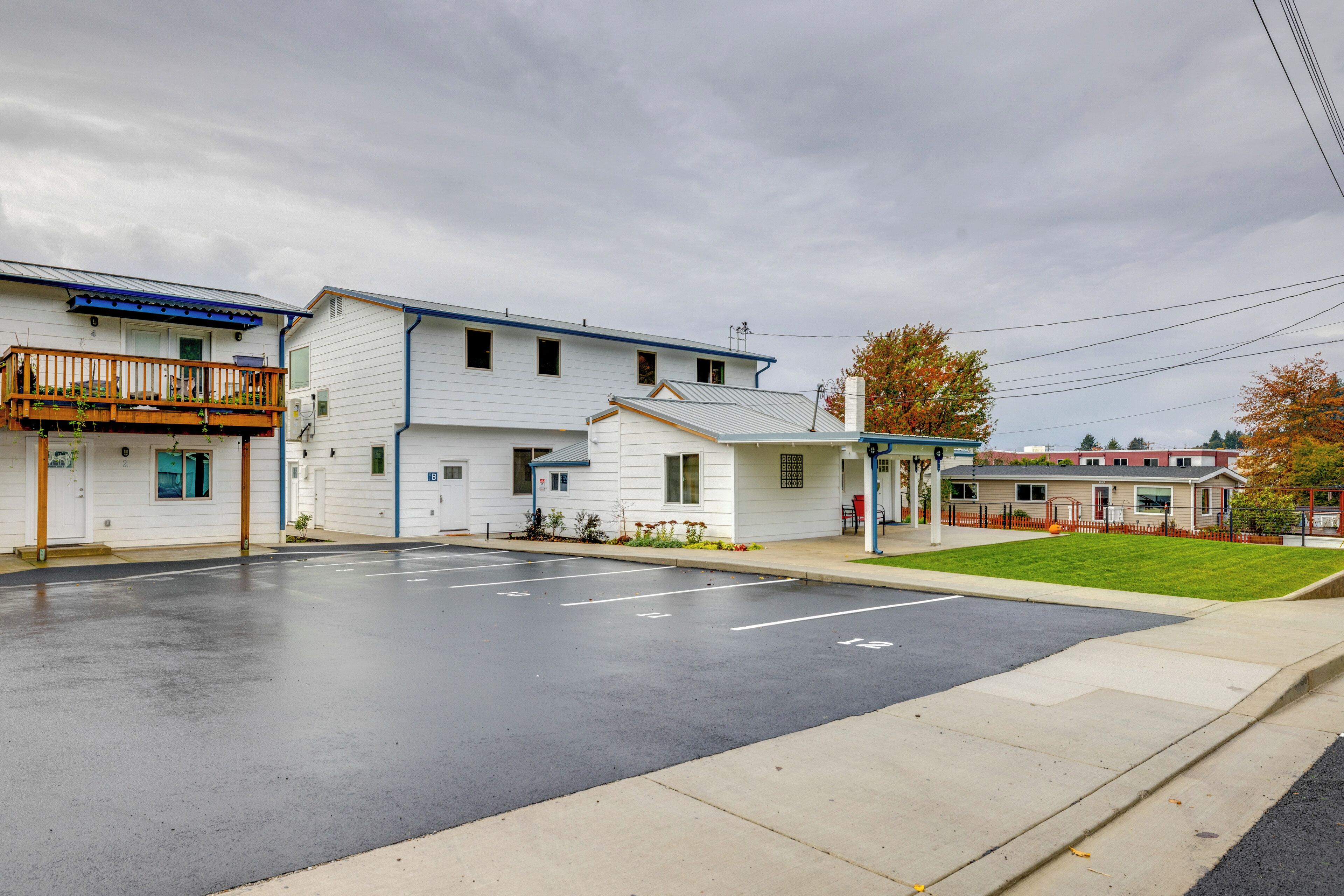 A two-story motel with a parking lot in front.