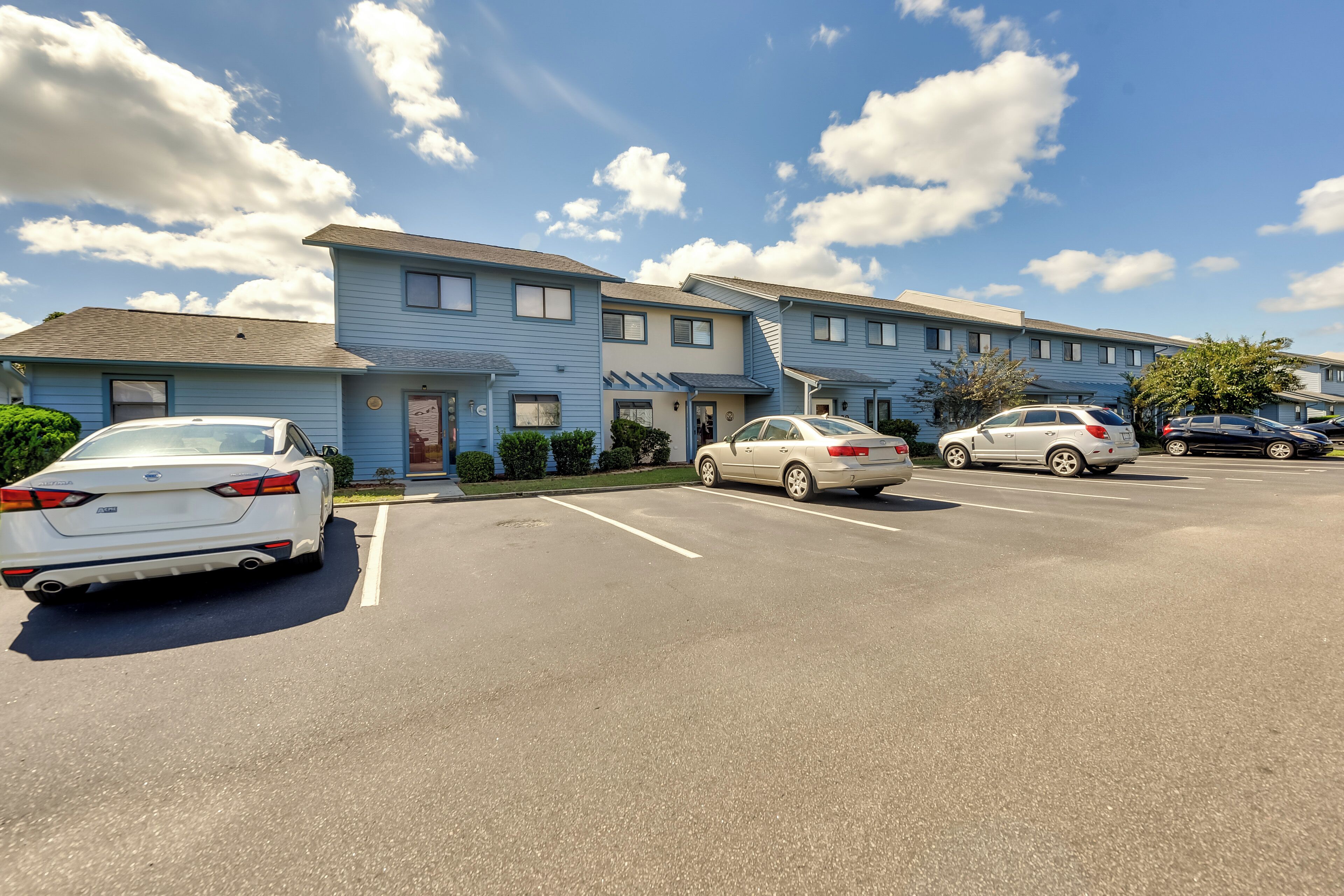 A multi-story parking garage with several cars parked.