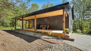 A modern house with a wooden deck, a covered porch, and a stone pathway. - Galena Cabin on 20 Acres: 5 Mi to Downtown! (Galena)