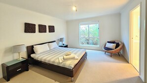 A bedroom with a bed, bedside tables, a window, and a chair. - Tallara @ Robe - Stop and stay a while (Robe)