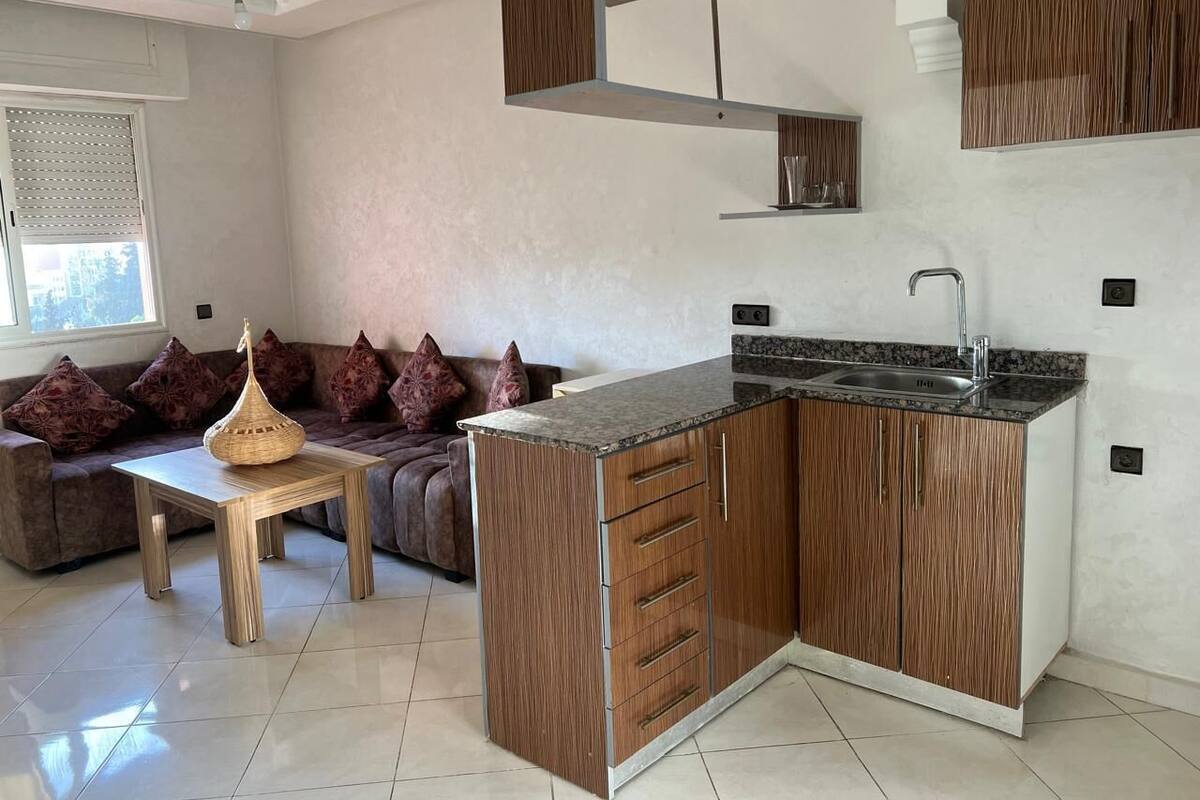 A modern kitchen with wooden cabinets, a granite countertop, and a built-in sink.