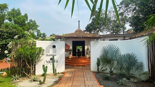 Un sendero conduce a un edificio con un cartel que dice 'Habitus Mogara'.