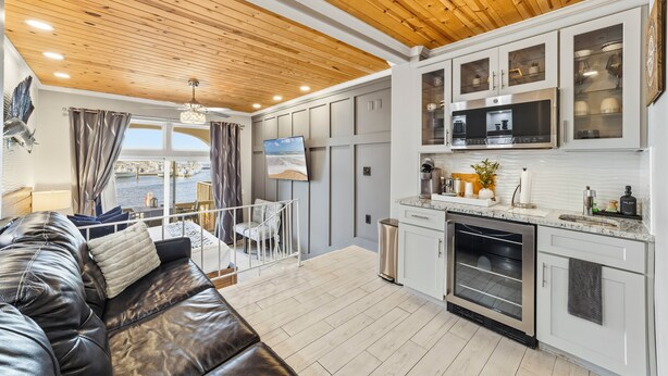 A modern kitchen with white cabinets and a stainless steel oven. - Inn at Camachee Harbor by Coolvacay (St. Augustine)