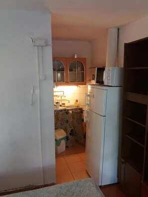Fridge, microwave, cookware/dishes/utensils, dining tables