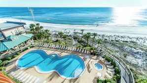A resort pool with a view of the beach and ocean.